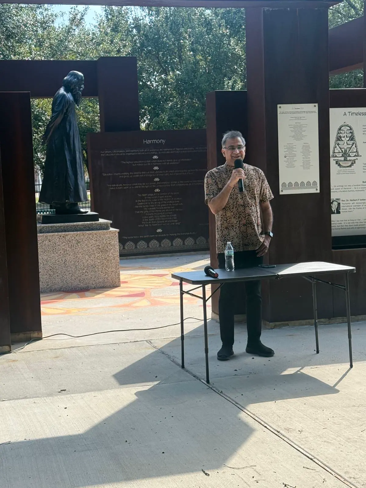 Guest speaking beside tagore statue â An Inspiring Conversation with Dr. Rabindra Chakraborty
