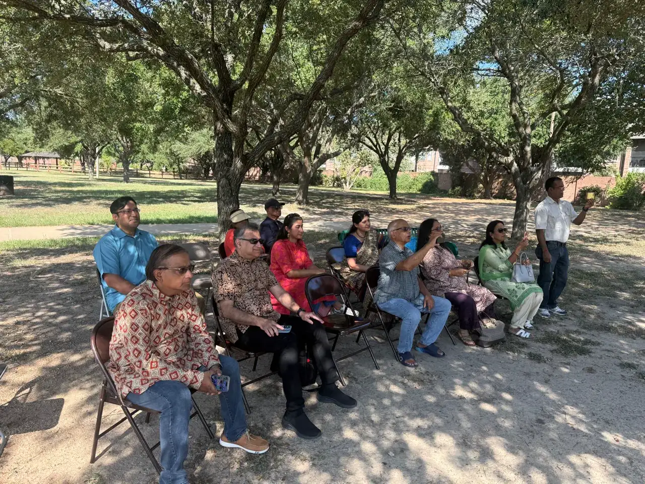 Attendees seated under the trees â An Inspiring Conversation with Dr. Rabindra Chakraborty