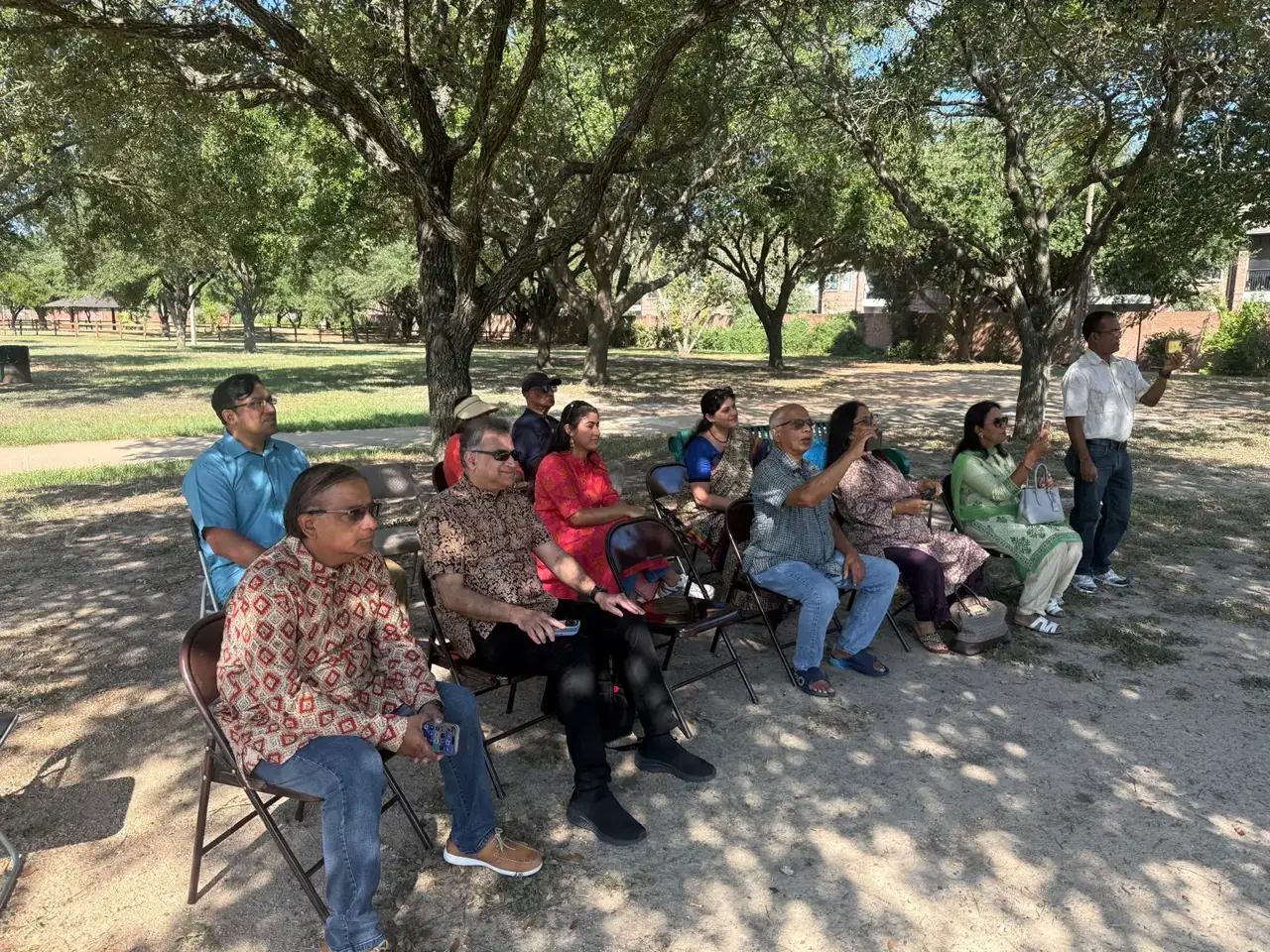 Attendees listening in the shade â An Inspiring Conversation with Dr. Rabindra Chakraborty