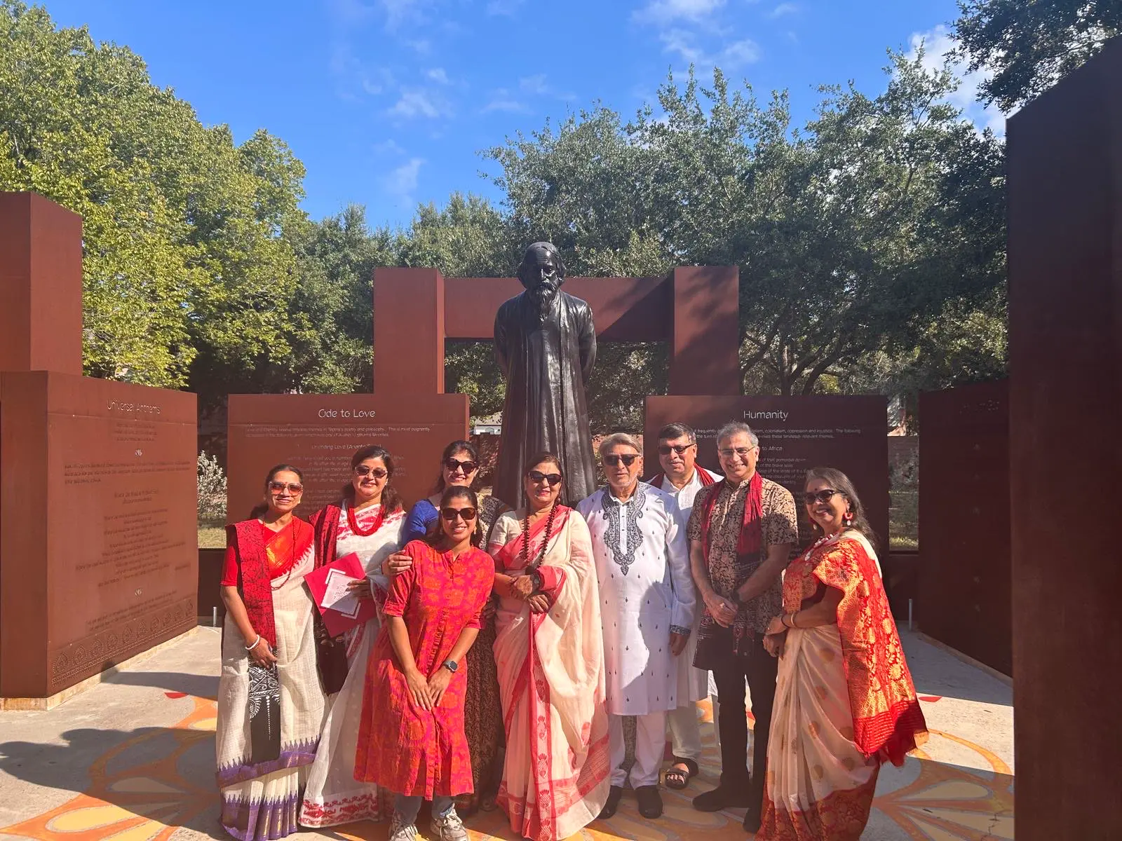 Guests posing in front of the statue â An Inspiring Conversation with Dr. Rabindra Chakraborty